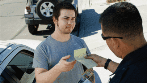 a man receiving a ticket from a male cop